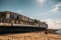 Old vintage abandoned rusted ship run aground after shipwreck accident in beginning of XX century in Crimean coast on sand beach Royalty Free Stock Photo