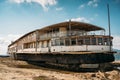 Old vintage abandoned rusted ship run aground after shipwreck accident in beginning of XX century in Crimean coast on sand beach Royalty Free Stock Photo