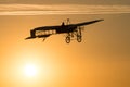 Old vintage airplane flying in an orange sky at sunset Royalty Free Stock Photo