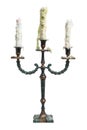 Old vintage ancient baroque metal candlestick with three white melted candles Royalty Free Stock Photo