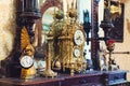 Old vintage antique bronze clock and utensil on wooden shelf, Antiques concept Royalty Free Stock Photo