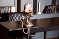 Old vintage antique candlestick telephone on the business working table working on the past Royalty Free Stock Photo