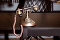 Old vintage antique candlestick telephone on the business working table working on the past Royalty Free Stock Photo