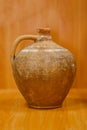 Old vintage antique earthenware jug on the table. Vintage style. Vessel for water , made for Scythian