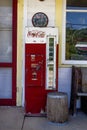 Missouri, United States, circa June - old antique glass bottle coke machine on porch of antique store route 66