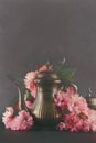 Old, vintage antique mocha coffee pot decorated with cherry blossom flowers, dark moody shot