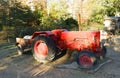 Old vintage antique red farm working tractor outside in the sun on a clear day Royalty Free Stock Photo