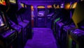 Old Vintage Arcade Video Games in an empty dark gaming room with purple light Royalty Free Stock Photo