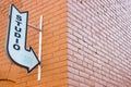 Old Vintage Arrow Studio Sign Pointing on an Urban Brick Wall