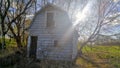 Old vintage barn in countryside with sun peaking through Royalty Free Stock Photo