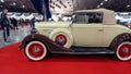 old vintage beige brown 1934 Chevrolet Chevy Master coupe cabriolet on red carpet. Classic car show