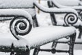 Old vintage bench in a park covered by the snow in winter Royalty Free Stock Photo