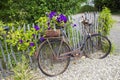 Old vintage bicycle with basket on a wooden fence