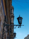 Old vintage black dark glass street lanterns hanging on textured wall of beautiful building in city of Saint Petersburg. Blue sky Royalty Free Stock Photo