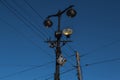 Old vintage black decorative lantern with glass on pillars. Three street lamps on two pole in sun light. Blue sky gradient Royalty Free Stock Photo