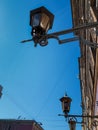 Old vintage black glass street lanterns hanging on wall of beautiful building in of Saint Petersburg in the light of sun. Blue sky Royalty Free Stock Photo