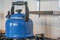 Blue old fashioned kettle on a stove Royalty Free Stock Photo