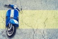 Old vintage blue scooter on concrete wall background. The concept of repair or rental scooters and motorcycle. Royalty Free Stock Photo