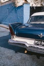 Old Vintage blue with white roof Plymouth Belvedere parked on the sideway on sunny day after the rain Royalty Free Stock Photo