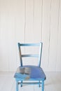 Old vintage blue wooden chair on a white background