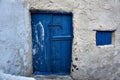 Old vintage blue wooden door with rustic stone wall Royalty Free Stock Photo