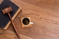 Old vintage book with judge hammer and cup of coffee. Royalty Free Stock Photo