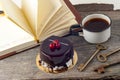 Old vintage books, cup of tea, cake and keys on rustic wooden table Royalty Free Stock Photo