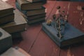 Old vintage books on a red wooden table and a dry flower