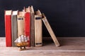 Old vintage books standing in a row on wooden bookshelf. Royalty Free Stock Photo