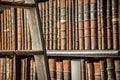 Old vintage books on wooden bookshelf and ladder in a library