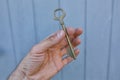 Old vintage brass door Key in mans hand Royalty Free Stock Photo