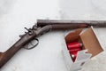 An old, vintage, break-action double-barrel shotgun featuring two triggers and two hammers.