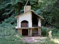 Old vintage brick barbecue oven in an overgrown forest Royalty Free Stock Photo