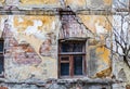 Old vintage brick house with cracks and old wooden window