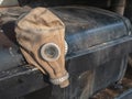 Old vintage broken gas mask on black kit box Royalty Free Stock Photo