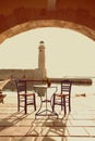 Old vintage cafe and lighthouse on the sea Rethymnon