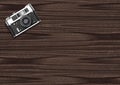 Old vintage camera on dark wooden background