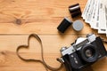 Old vintage camera, film and photos on wooden table Royalty Free Stock Photo