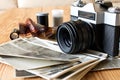 Old vintage camera, film and photos on wooden table Royalty Free Stock Photo