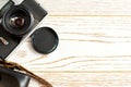 Old vintage camera with a leather case on the wooden surface Royalty Free Stock Photo