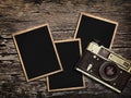 Old vintage camera and photos on a wooden background Royalty Free Stock Photo