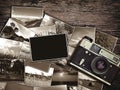 Old vintage camera and photos on a wooden background Royalty Free Stock Photo