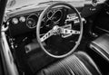 Old vintage car steering wheel and cockpit. Retro styled image of an old car radio inside classic car Chevrolet