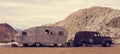 Old vintage caravan and truck abandoned in the desert