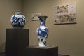 Vintage ceramic vase and statue of Chinese art on display in museum.