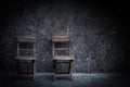 Old vintage chair wooden at dark concrete wall Royalty Free Stock Photo