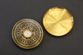 Old vintage chinese compass used in feng shui, golden item with cover, on black background. Royalty Free Stock Photo