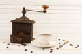 Old vintage coffee grinder with ceramic cup Royalty Free Stock Photo