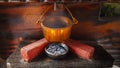 Old vintage cooking pot warming on charcoal