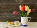 Old vintage cup, tukips and easter eggs on wooden Royalty Free Stock Photo